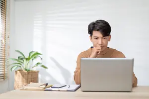 Freelancer working from home and looking at his computer screen