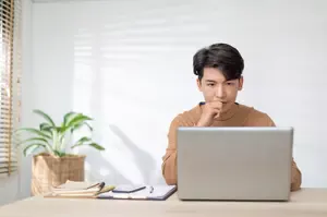 Freelancer working from home and looking at his computer screen