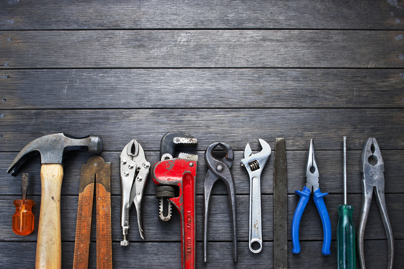 Basic tools hanging on a reclaimed wood wall