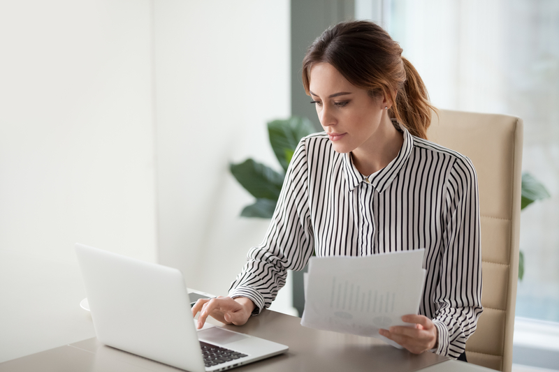 Business woman reviews a compilation engagement report